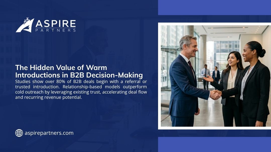 Three business professionals shaking hands in a corporate lobby, illustrating the hidden value of warm introductions in B2B decision-making and deal flow.