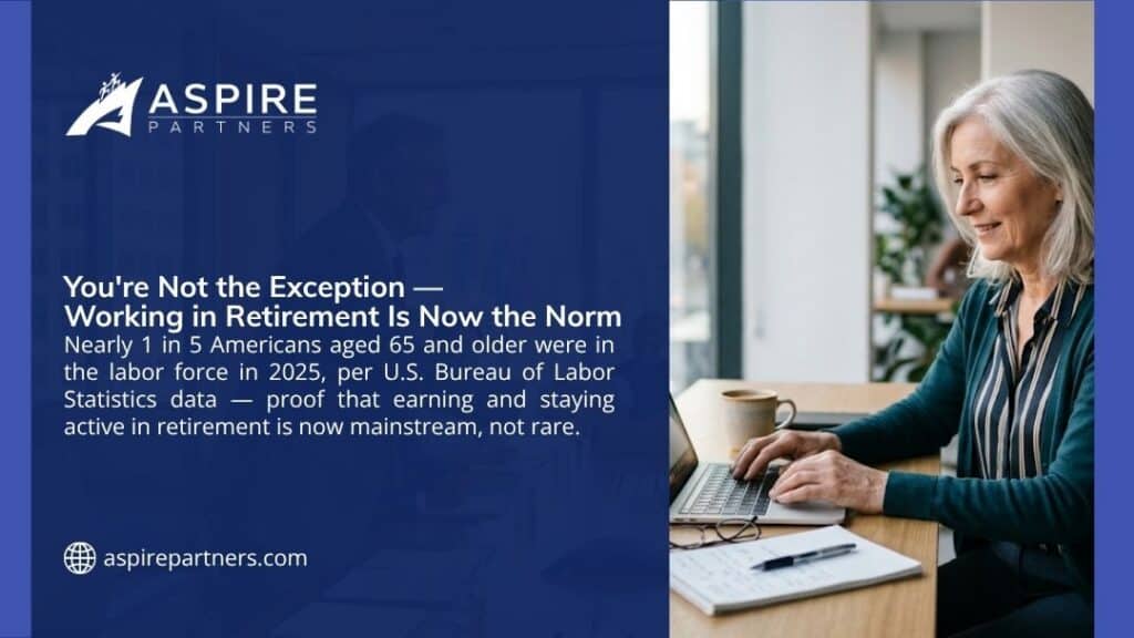 Older woman working on a laptop at a desk by a window, showing how working in retirement is now the norm for nearly 1 in 5 Americans over 65.