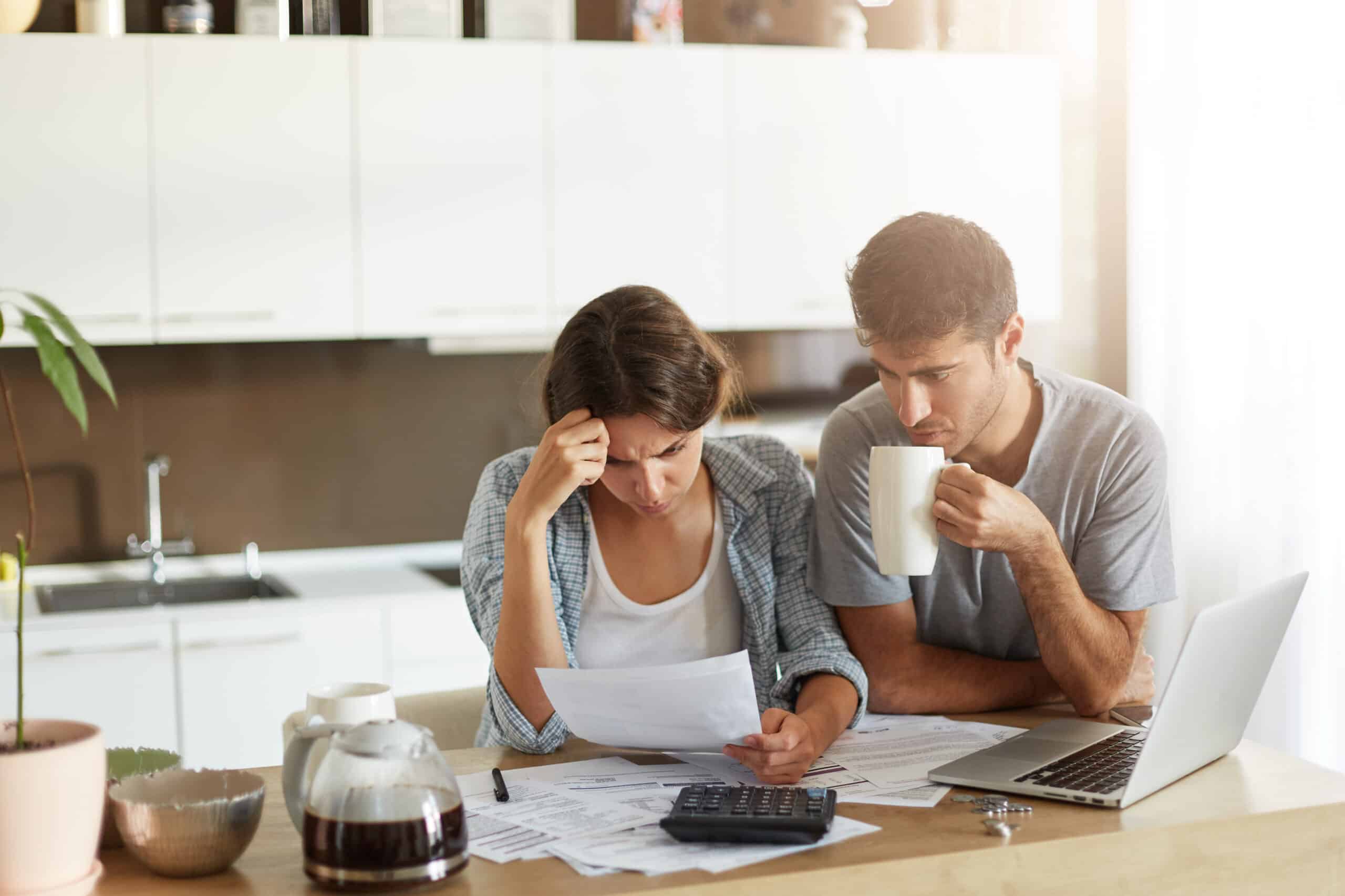 Young couple checking their budget