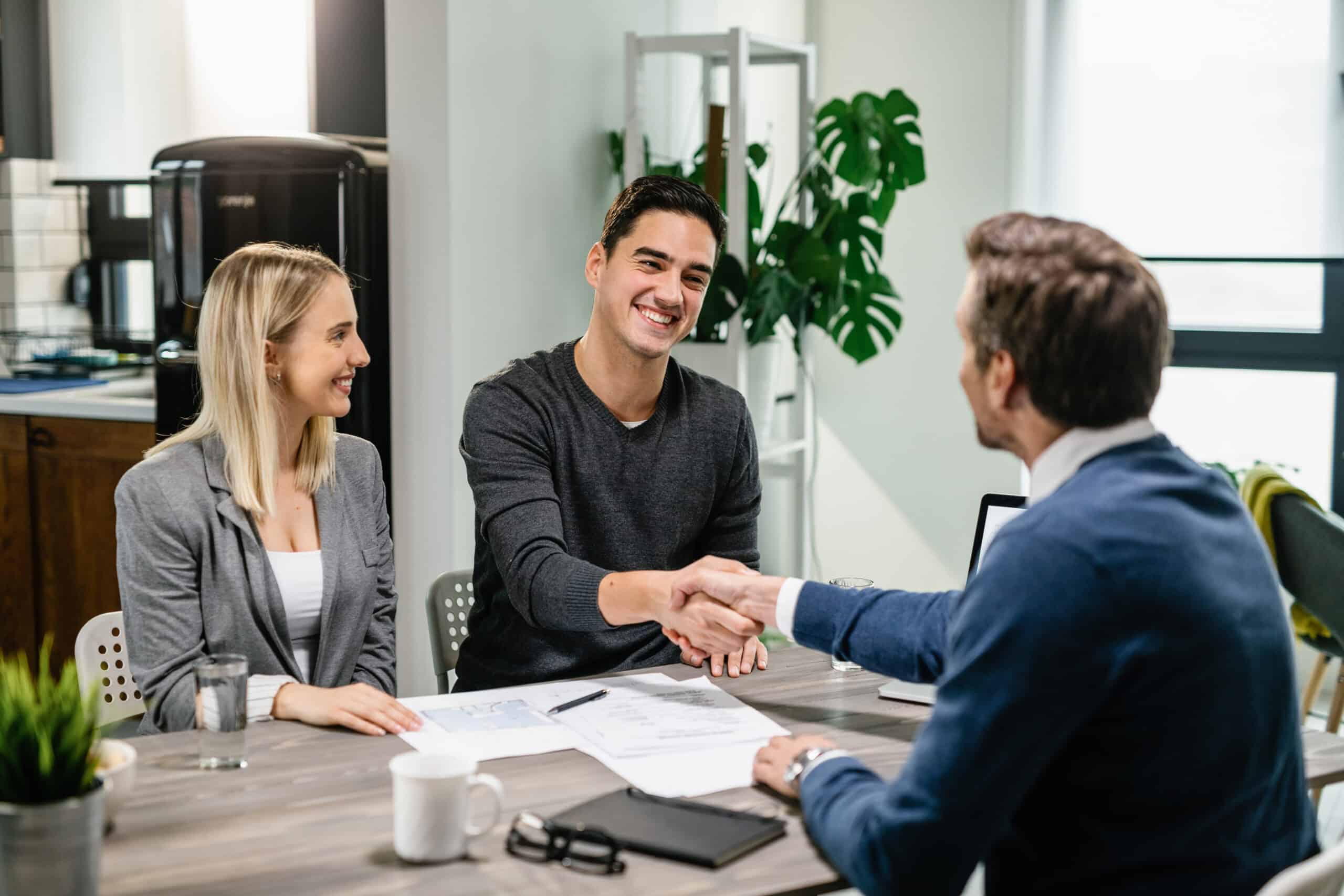 Couple making agreement with their financial advisor